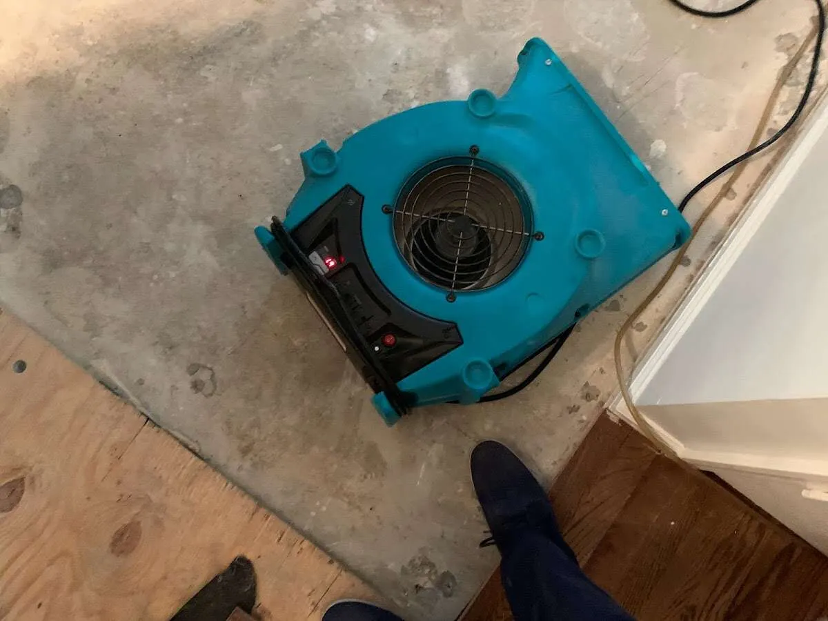 Air mover drying subfloor during Leak Detection & Repair in Stow